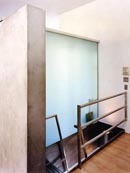 In the house, a huge glazed glass panel divides the shower threshold from the main bathroom