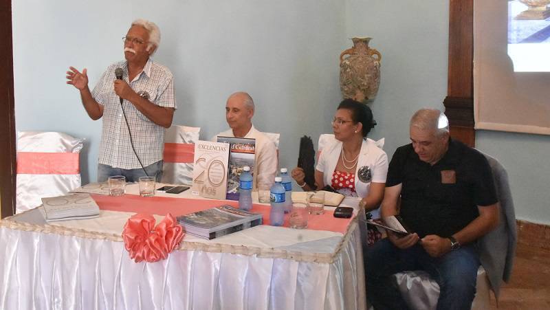personas junto a una mesa- presentación revista excelencias